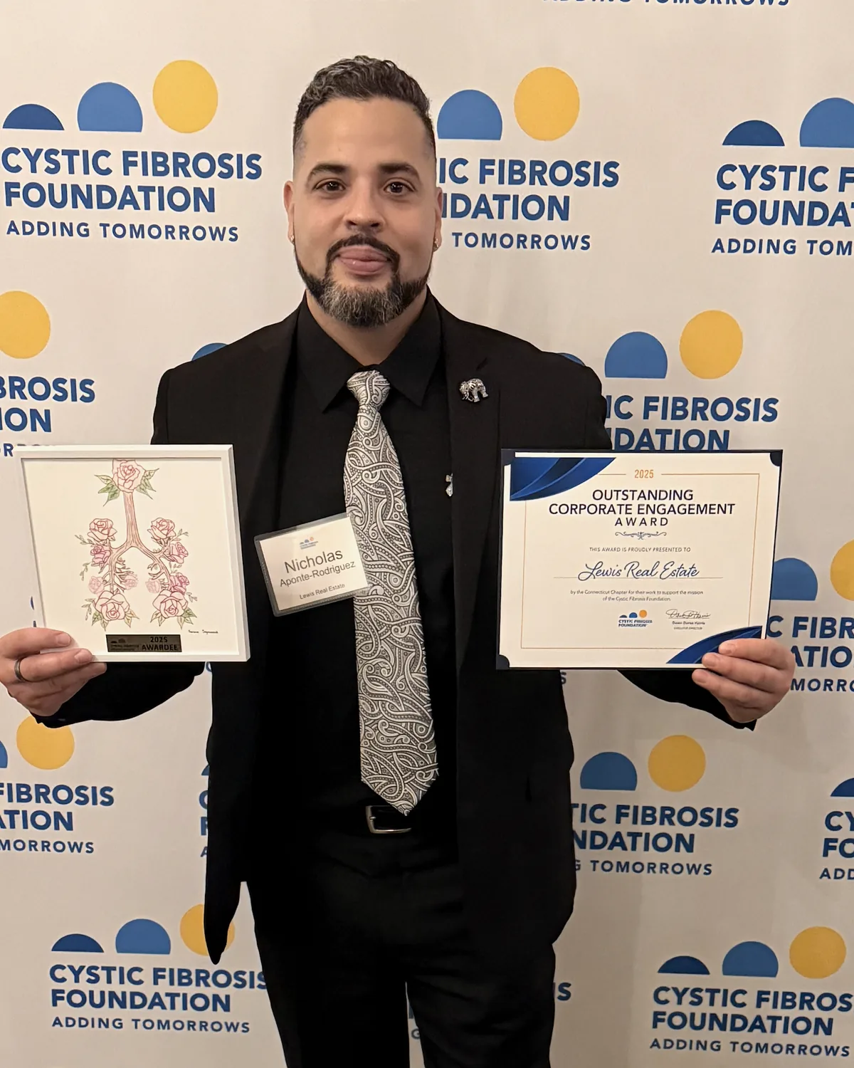 Nicholas accepting the Cystic Fibrosis Foundation's 2025 Outstanding Corporate Engagement Award on behalf of Lewis Real Estate.