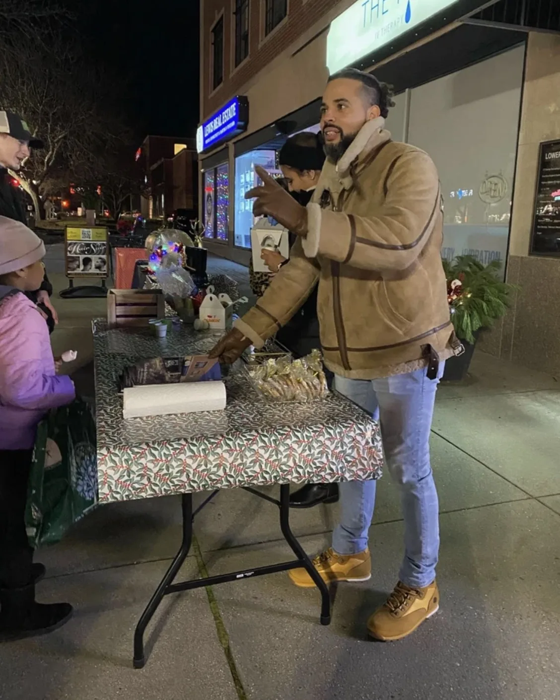 Nicholas at a community table outside on a winter evening in West Hartford.