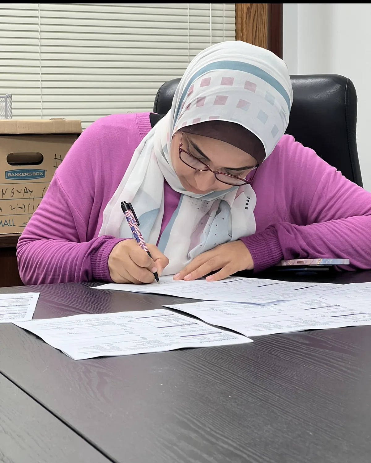 A client signing documents at a conference table.