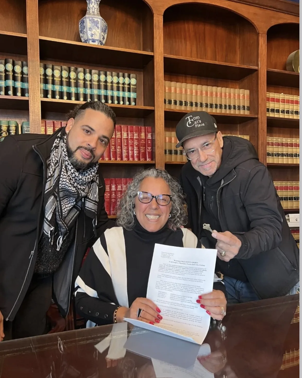 Nicholas with clients at the closing table as they sign the deed.
