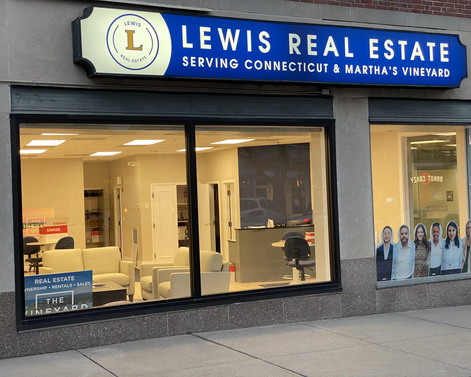 The Lewis Real Estate storefront, with its blue sign reading Serving Connecticut and Martha's Vineyard.